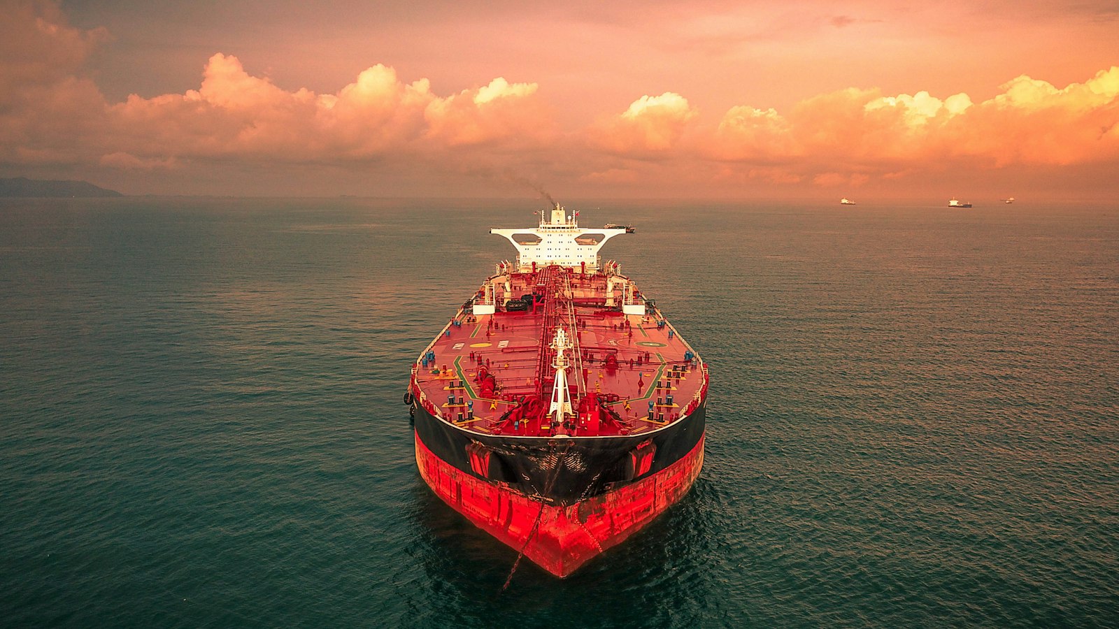 Crude oil tanker under way on a calm sea at sunset