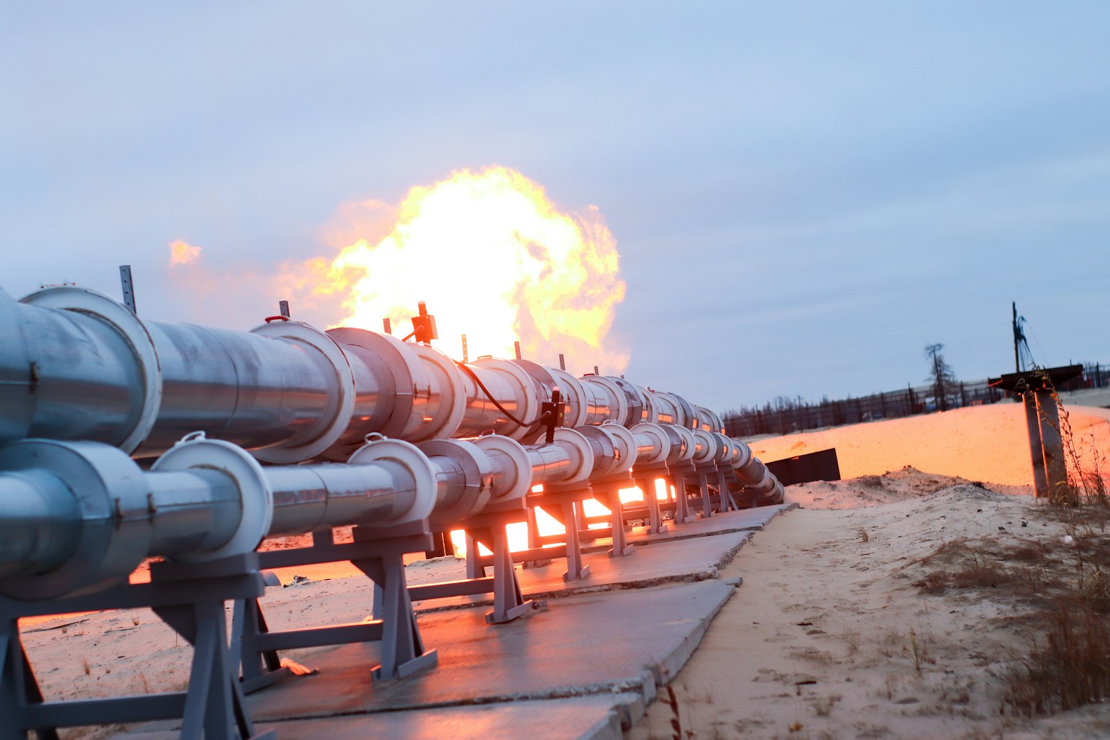 Twin pipeline running toward a gas flare